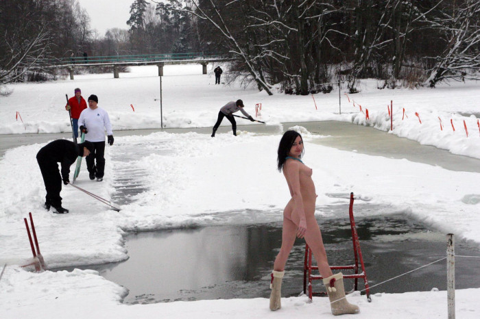 Naked brunette posing naked near ice-hole