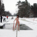 Naked brunette posing naked near ice-hole