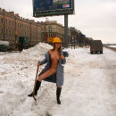 Naked russian helps workers at a construction site