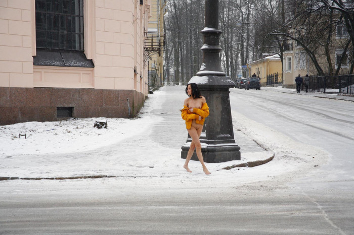 Russian brunette exhibitionist walks naked at public street at winter