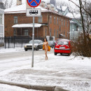 Russian brunette exhibitionist walks naked at public street at winter