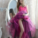 Sporty babe in bright purple dress in bed