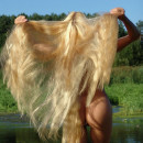 Sporty blonde with really long hair at the lake