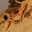 Two russian girls widely spread legs on the sandy shore