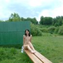 Brunette with small tits is undressing at park