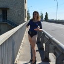 Curly girl in blue dress exposes her big hairy pussy on the bridge