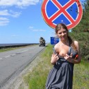 Girl lifts up her skirt off road