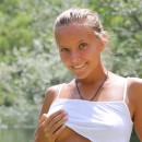 Smiling teen with tanned body and sexy underwear at river