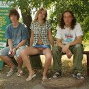 Blonde in denim skirt undressing in front of auto mechanics