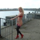 Blonde milf posing in various poses at pier