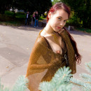 Red-haired babe in a gold dress shines hairy pussy in the park