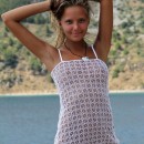 Sexy young girl in a beautiful transparent dress outdoors