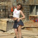 Young girl undressing at construction