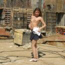 Young girl undressing at construction