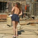 Young girl undressing at construction