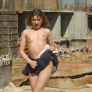 Young girl undressing at construction