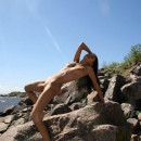 Sexiest russian teen with dark skin posing on rocks at sea