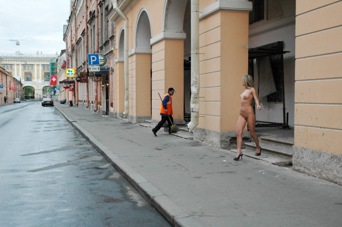 Nude blonde walking along the streets in the early morning