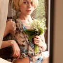 Shorthair blonde with lily of the valley posing bottomless