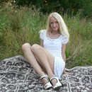 Blonde with long legs shows pussy outdoors
