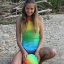 Young russian removes bright swimsuit at beach