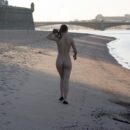 Naked brunette doing exercises in a tourist spot