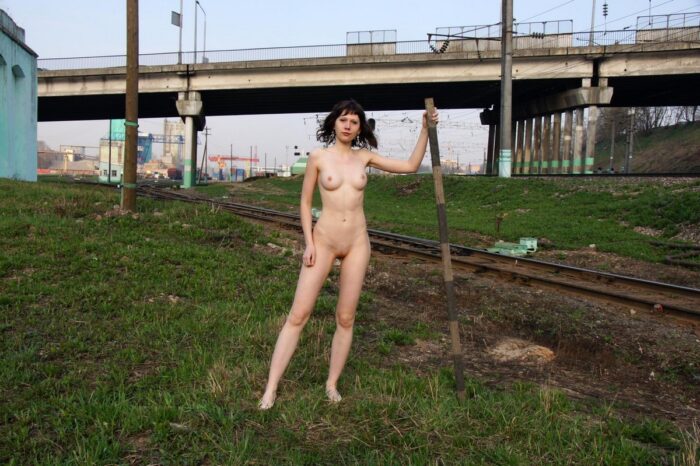 Naked russian brunette on railroad tracks