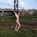 Naked russian brunette on railroad tracks