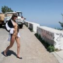 Naked Masha E posing on mountain road