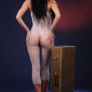 Brunette in clothing fishnet posing at studio