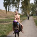 Blonde naked riding a pony near Kremlin