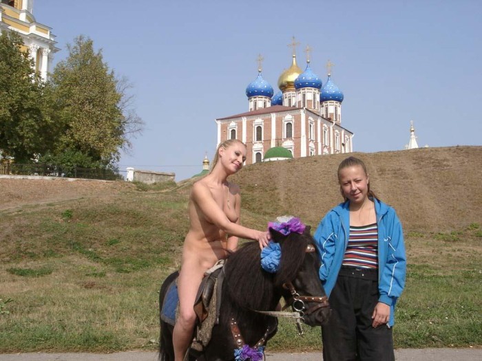 Blonde naked riding a pony near Kremlin
