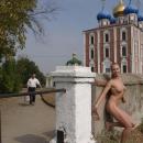 Slender blonde with dreadlocks posing in Ryazan Kremlin