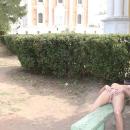 Slender blonde with dreadlocks posing in Ryazan Kremlin