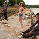 Teen titless Juliette D posing with migrant workers