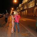 Russian girl takes off a pink dress on a night promenade