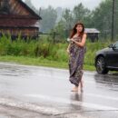 Nude girl buys the honey in the rain