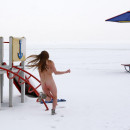 A youthfull chick running around the playground in winter