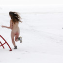 A youthfull chick running around the playground in winter