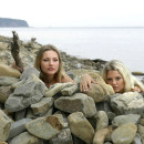 Two wonderful blondes on the rocky shore