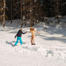 Redhead girl snowboarding in the mountains without any clothes