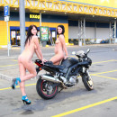 Two amateur brunettes posing naked on shopping mall parking