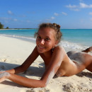 Young tanned beauty Mango A on the white beach