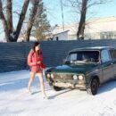 Slim girl in frosty day in front of a group of men