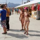 Naked girl selects souvenirs in the resort town