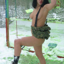 Busty brunette plays paintball at winter