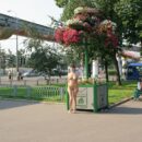 Hot brunette posing naked at Moscow park entrance