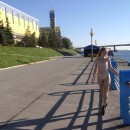 Naked girl with small tits on the waterfront