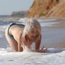 Blonde Mila I takes a swimsuit in a stormy sea