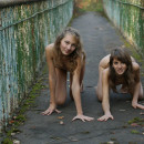Two teens on old bridge